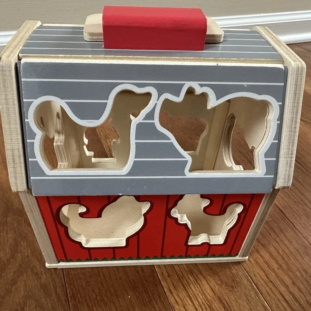 Melissa & Doug‎ Wooden Take-Along Sorting Barn Toy with Flip-Up Roof, 9 Pieces.